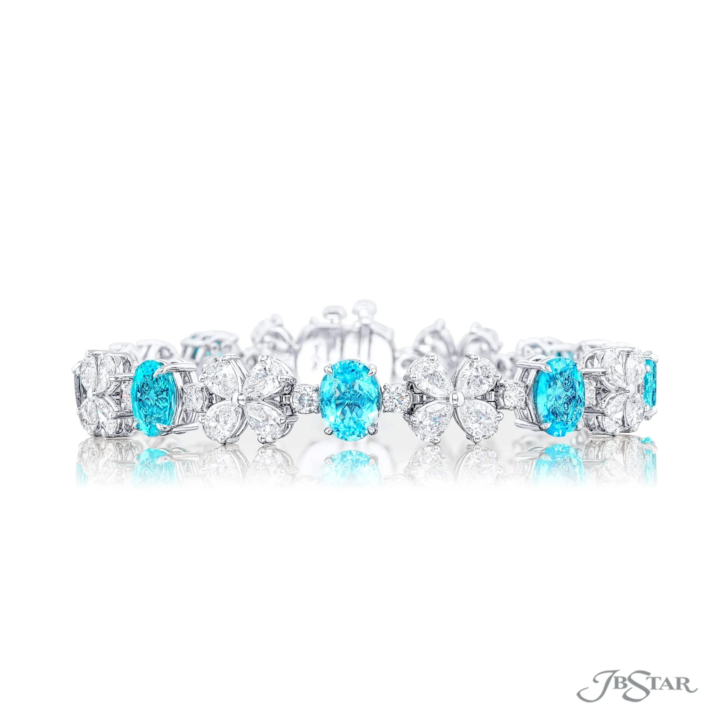 Paraibas alternating between pear shaped and round diamonds.