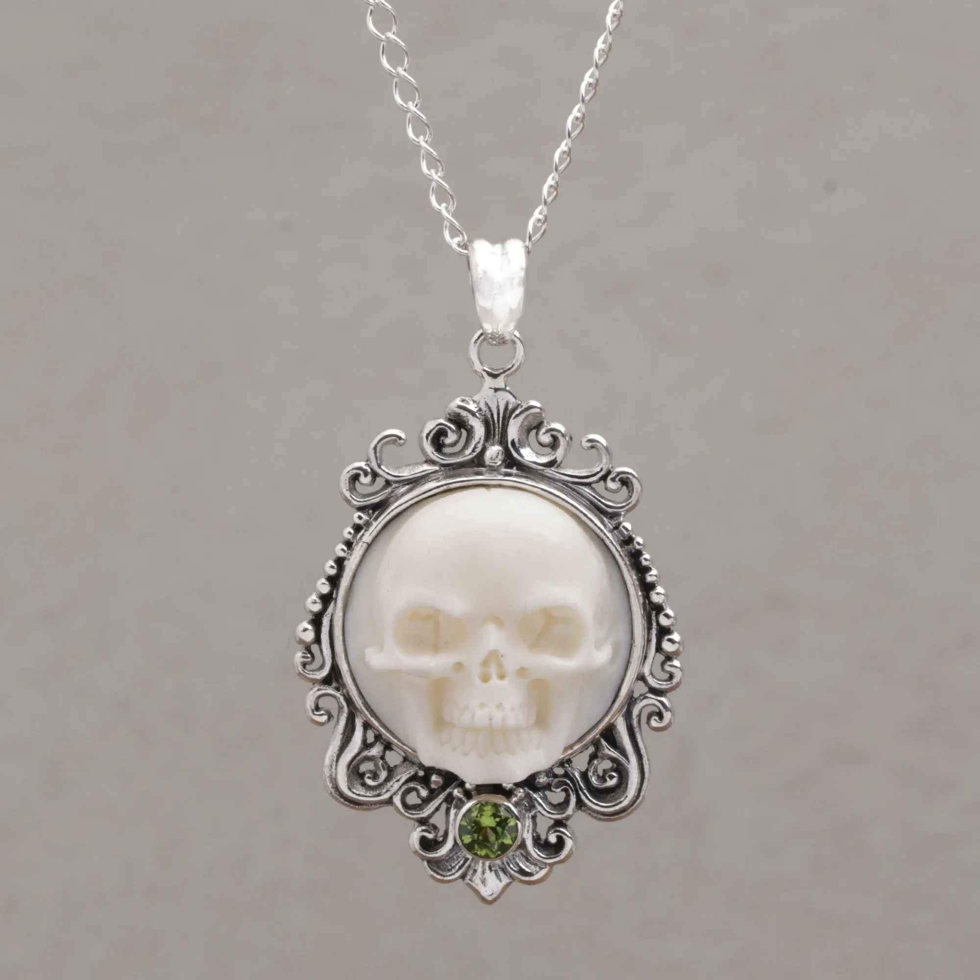 Peridot and Bone White Skull Pendant Necklace from Bali - Skull Stare in White | NOVICA