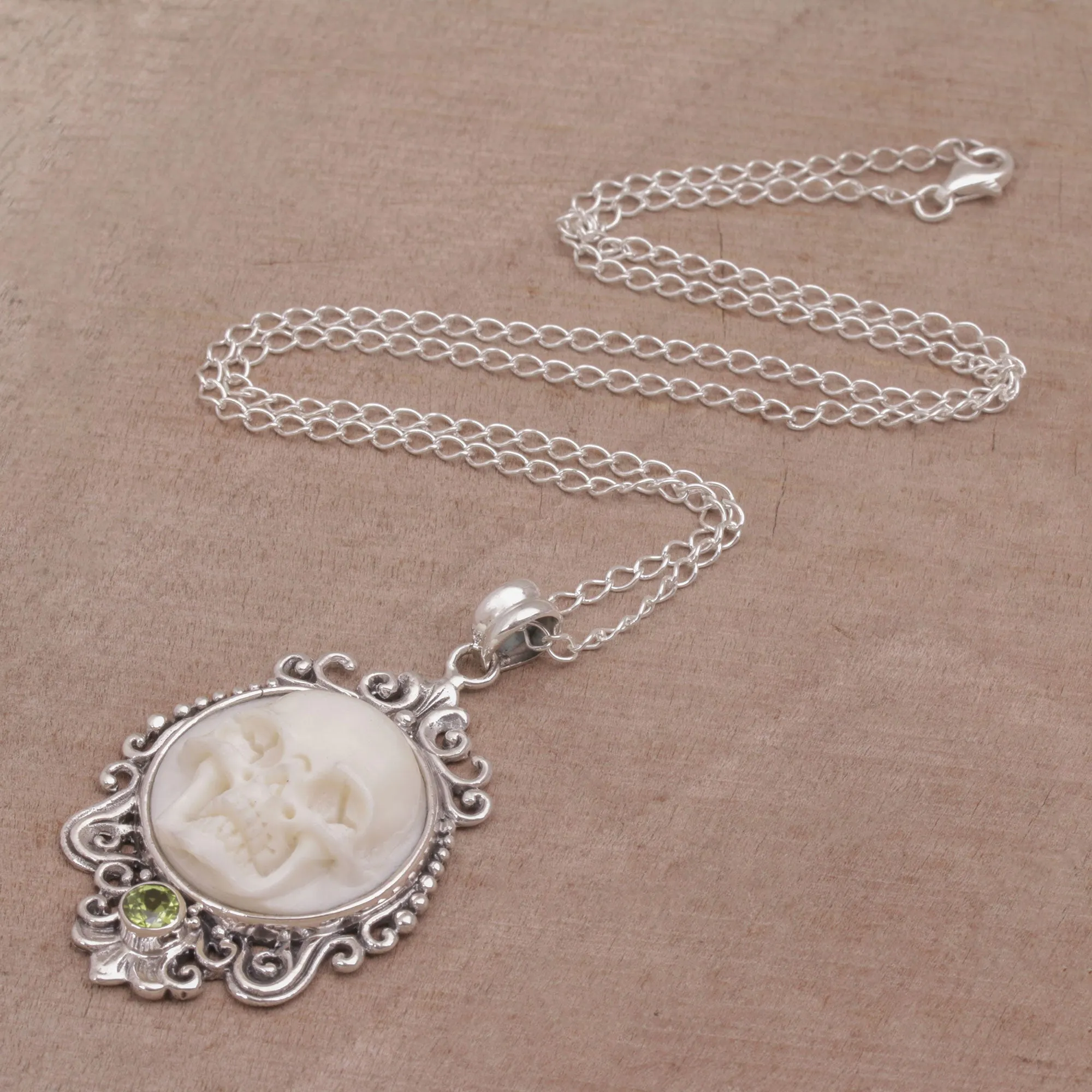 Peridot and Bone White Skull Pendant Necklace from Bali - Skull Stare in White | NOVICA